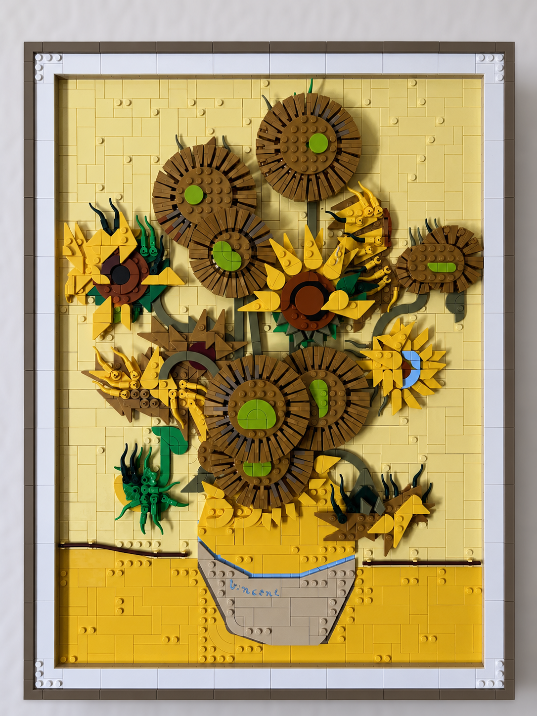 A framed LEGO sunflower artwork
